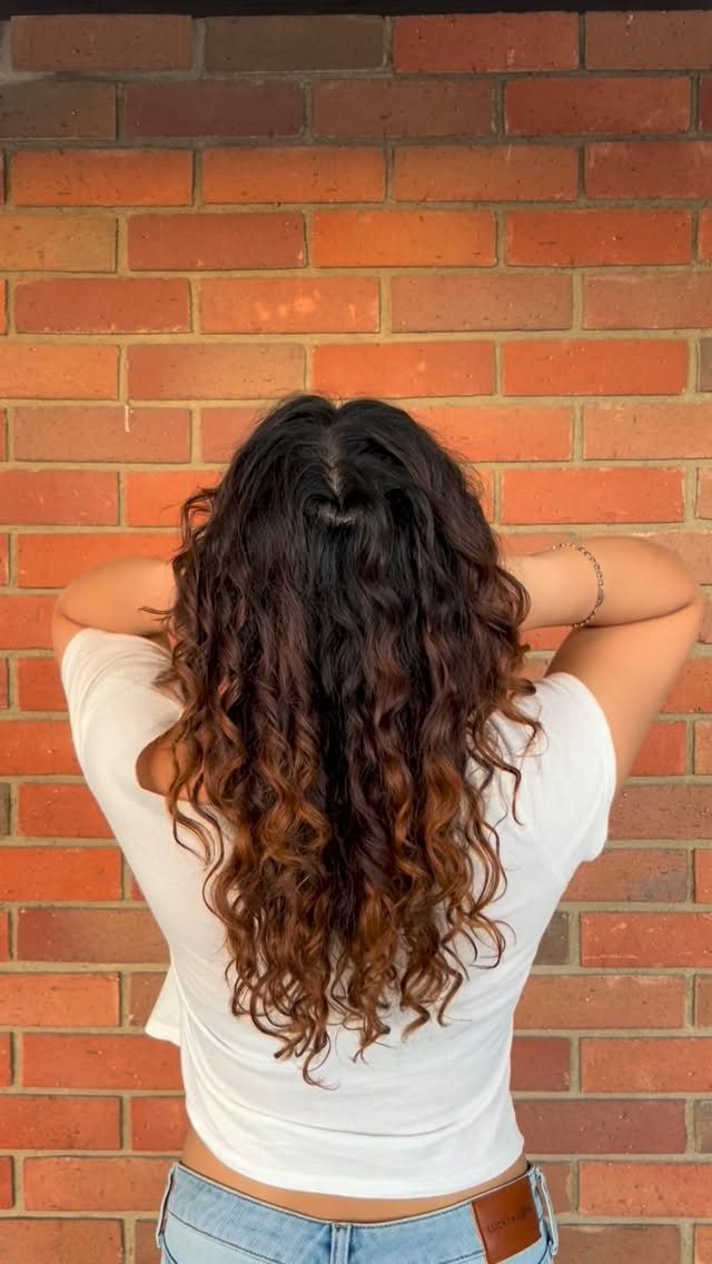 Curly haircut with long curls and copper ends, back view